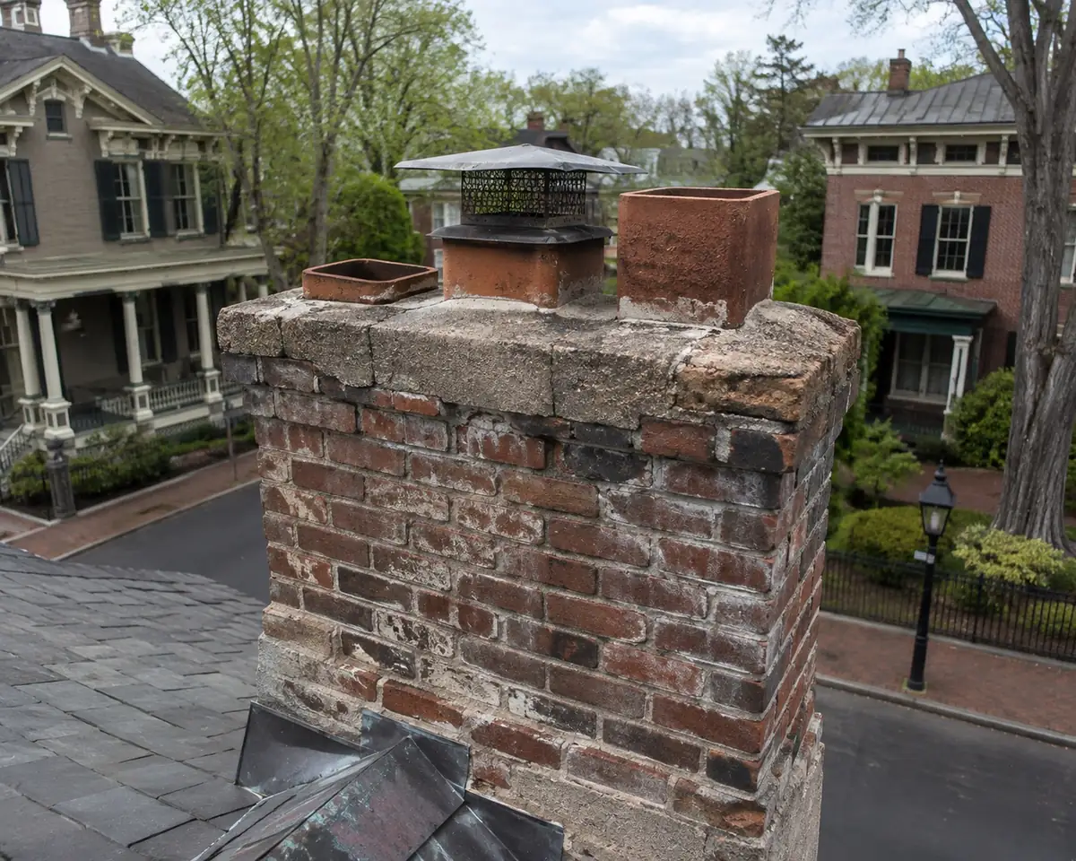 Older brick chimney with clay flue tiles on a historic house in Goshen, New York